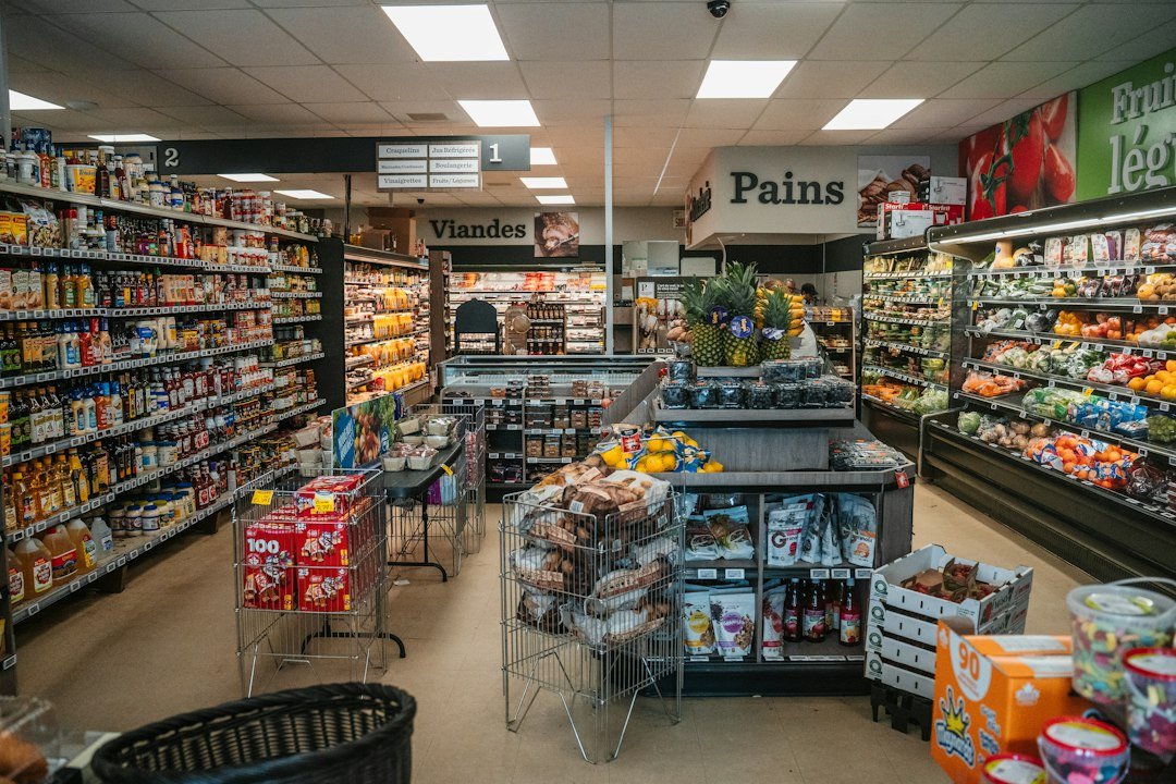 Supermarket aisle with shelves of groceries and fresh produce
